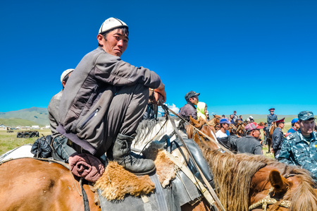 Karkara, Kyrgyzstan - circa August 2011: Young native man sits on horseback at Independence day festival in Karkara. Documentary editorial.のeditorial素材