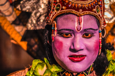 Guwahati, Assam - circa April 2012: Photo of woman with large crown and colours on her face looking...