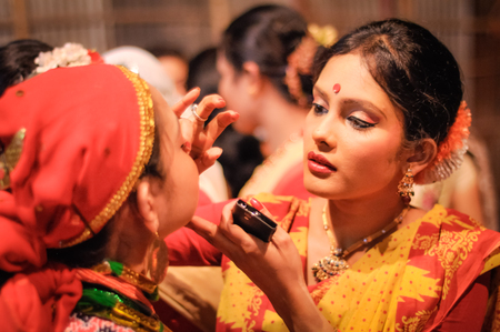 Guwahati, Assam - circa April 2012: Beautiful girl with red dot on her forehead wears sari before their performence at Bihu festival in Guwahati, Assam. Documentary editorial.のeditorial素材