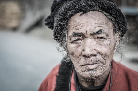 Ziro, Arunachal Pradesh - circa March 2012: Old man with black cap on his head and wrinkled face in Ziro, Arunachal Pradesh. Documentary editorial.のeditorial素材