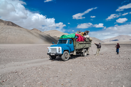 Karakul, Tajikistan - circa September 2011: Photo of lorry with heavy load in Karakul, Tajikistan. Documentary editorial.のeditorial素材