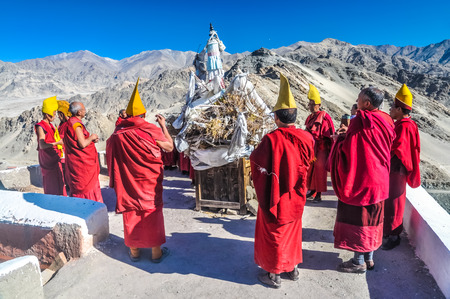 Thiksey, Ladakh - circa November 2011: Monks dressed in red with typical yellow hats during ceremony at Thiksey monastery, Ladakh. Documentary editorial.のeditorial素材