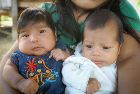Villa Alcira, Bolivia -circa June 2009: Mother holds her two children in her arms at Villa Alcira. Documentary editorial.のeditorial素材