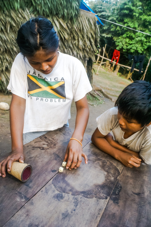 Mashaquipe, Bolivia - circa June 2009: Native children play dice at Mashaquipe, Bolivia. Documentary...