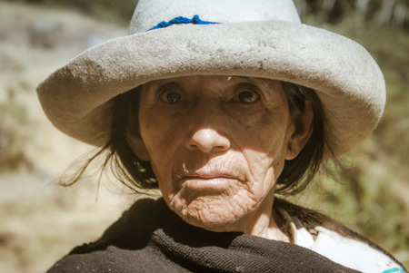 Parque Nacional Huascaran, Peru - circa July 2009: Old native woman with tanned wrinkled face and white hat at Parque Nacional Huascaran, Alpamayo in Peru. Documentary editorial.のeditorial素材