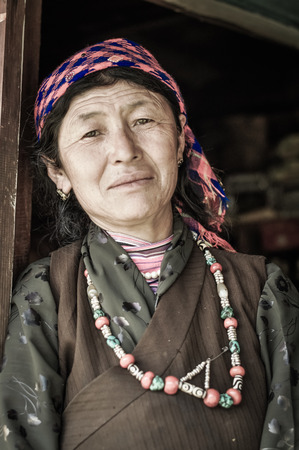 Kanchenjunga Trek, Nepal - circa April 2012: Beautiful woman with colourful headcloth and necklace in Kanchenjunga Trek, Nepal. Documentary editorial.のeditorial素材
