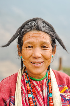 Khinmey Gompa and Ugyenling Temple, Arunachal Pradesh - circa February 2012: Native woman with colourful necklace made of beads in Khinmey Gompa, Arunachal Pradesh. Documentary editorial.のeditorial素材