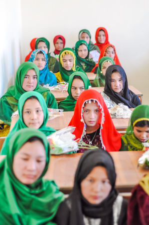 Afghanistan - circa October 2011: Young native girls wear colourful hijabs and pose at ADRA school opening in Afghanistan. Documentary editorial.のeditorial素材