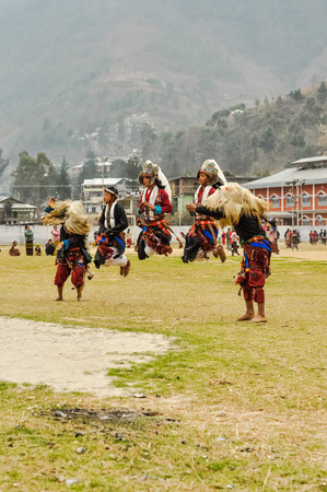 Dirang, Arunachal Pradesh - circa February 2012: Photo of young native boys in traditional costumes during dance performance in Dirang, Arunachal Pradesh. Documentary editorial.のeditorial素材