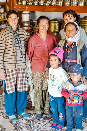 Thiksey, Ladakh - circa November 2011: Women pose with two small children in Thiksey, Ladakh. Documentary editorial.のeditorial素材