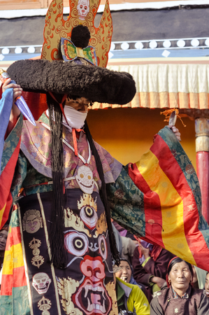 Thiksey, Ladakh - circa November 2011: Man in traditional mask and costume dances at Thiksey festival, Ladakh. Documentary editorial.のeditorial素材