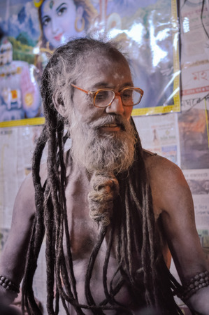 Ganga Sagar, West Bengal - circa January 2012: Man covered with white powder and with dreadlocks poses in Ganga Sagar, West Bengal. Documentary editorial.のeditorial素材