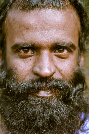 Shantiniketan, West Bengal - circa January 2012: Handsome man with long black beard looks up at Baul music festival near Shantiniketan, West Bengal. Documentary editorial.のeditorial素材