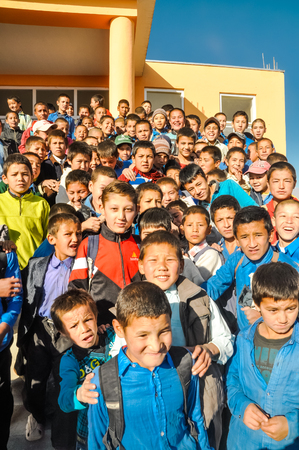 Afghanistan - circa October 2011: Small native children pose at ADRA school opening and stand in front of their school in Afghanistan. Documentary editorial.のeditorial素材