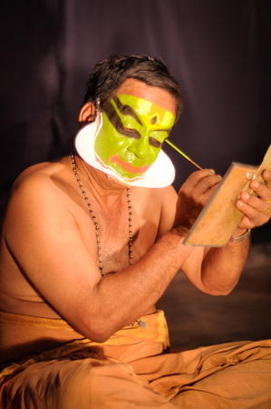 Ernakulam, Kerala - circa February 2012: Man paints his face for performance at See India Foundation, Kathakali, classical Indian dance-drama in Ernakulam, Kerala. Documentary editorial.のeditorial素材