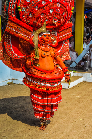 Thottada, south of Kannur, Kerala - circa January 2012: Beautiful and artistic mask of young traditional ritual dancer at Theyyam near Thottada, south of Kannur, Kerala. Documentary editorial.のeditorial素材