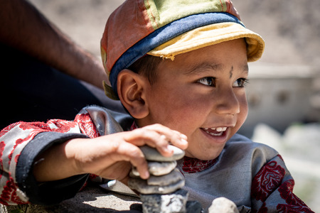 Ladakh, India - August 29, 2018: Portrait of a cute  smiling indigenous boy in Ladakh, India. Illustrative editorial.のeditorial素材