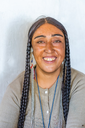 Ladakh, India - August 29, 2018: Portrait of an indigenous smiling young woman in Ladakh, India. Illustrative editorial.のeditorial素材