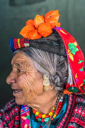 Ladakh, India - August 29, 2018: Portrait of an old indigenous woman with traditional colorful hat in Ladakh, India. Illustrative editorial.のeditorial素材