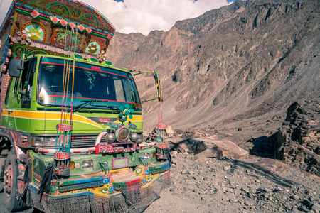 Decorated truck in Pakistan on dangerous road in the mountains.の写真素材