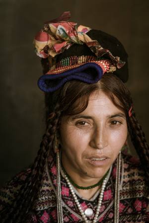 Ladakh, India - August 29, 2018: Portrait of a middle age indigenous woman with traditional hat and clothes in Ladakh, India. Illustrative editorial.のeditorial素材
