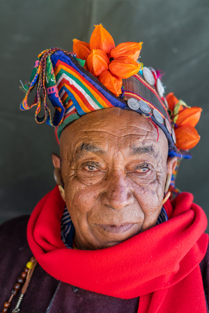 Ladakh, India - August 29, 2018: Portrait of an old indigenous man with traditional colorful hat in Ladakh, India. Illustrative editorial.のeditorial素材
