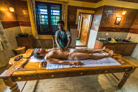 Karnataka, India - August 20, 2018: Young man undertaking a body massage in Indian spa. Illustrative editorial.のeditorial素材