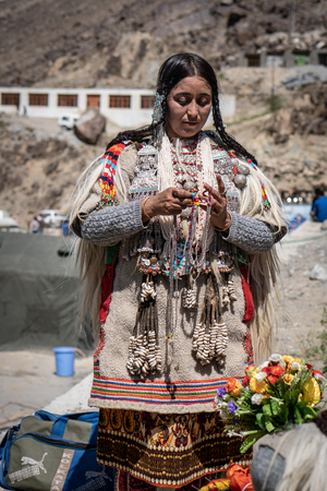 Ladakh, India - August 29, 2018: Portrait of an indigenous young woman in traditional costume in Ladakh, India. Illustrative editorial.のeditorial素材