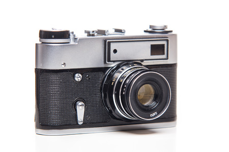 Classic 35mm old analog camera on white - studio shoot