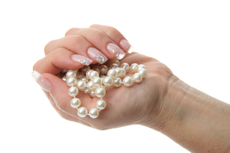 Woman hand holding pearl jeweleryの写真素材