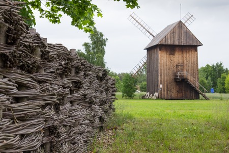 Wooden mill and braided fence in the countryside, Polandの写真素材