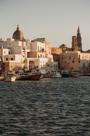View of scenic city scape and a fishing harbor with marina in Monopoli, Italyの写真素材
