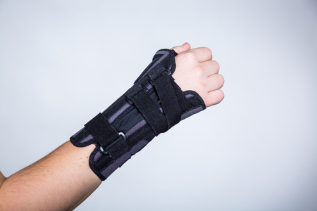 Hand in orthopedic orthosis on white backgroudの写真素材