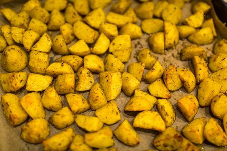 Traditional baked golden potatoes with Provencal spicesの写真素材