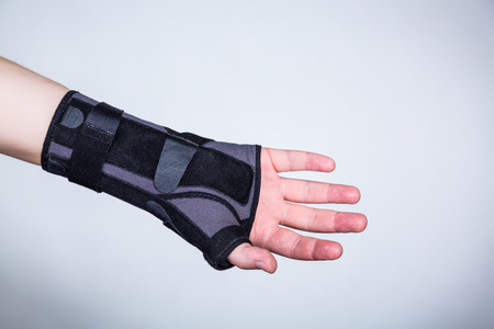 Hand in orthopedic orthosis on white backgroudの写真素材