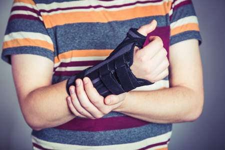 Man with hand in orthopedic black orthosisの写真素材