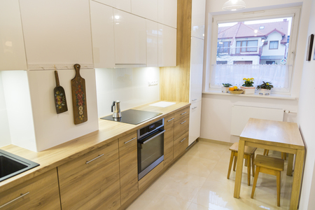 Aesthetic modern narrow kitchen with wooden furnituresの写真素材
