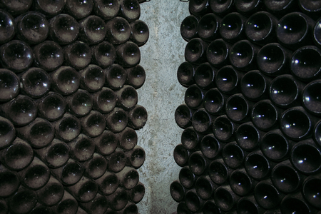 Antique wine bottles laying in wine cellar