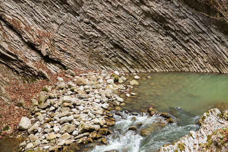 Interesting layered geological stone formation in river canyonの写真素材