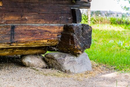 Fragment of old wooden farm house build on stoneの写真素材