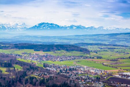 Panorama of alps and towns Wettswil, Stallikon and Bonstetten from odservation tower on Uetliberg mountain in Switzerlandの写真素材
