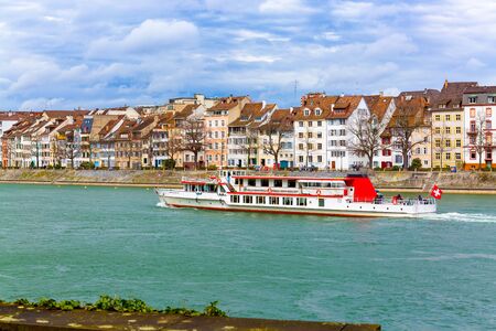 Ferry boat on Rhine river and old town building in city Basel, Switzerlandの写真素材