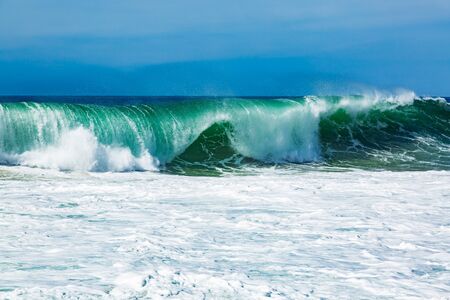 Big blue ocean waves creating white foam