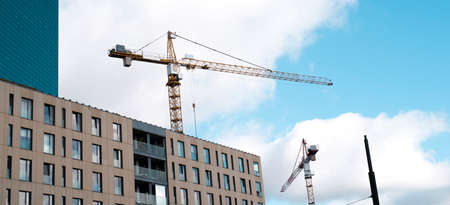 cranes against the sky and building