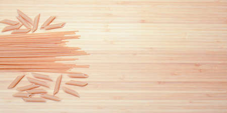 Raw pasta on the wooden tableの写真素材