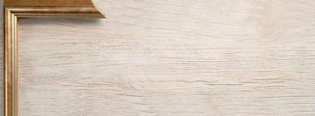 wooden background with gold frame with place for text