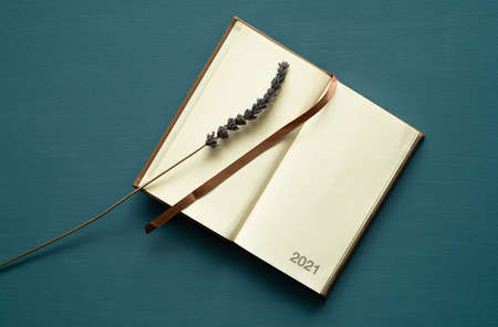 calendar 2021 with space for text, brown bookmark, lavender decoration, on a painted background,...