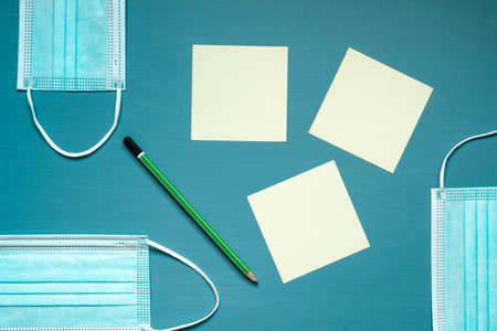 medical face masks, blue color, office, green pencil, reminders, yellow cards, on a blue and...
