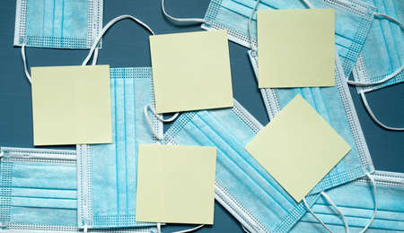 protective medical masks, blue color, reminders, yellow cards, photo from above