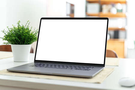 Laptop with blank screen on table in home interiorの写真素材